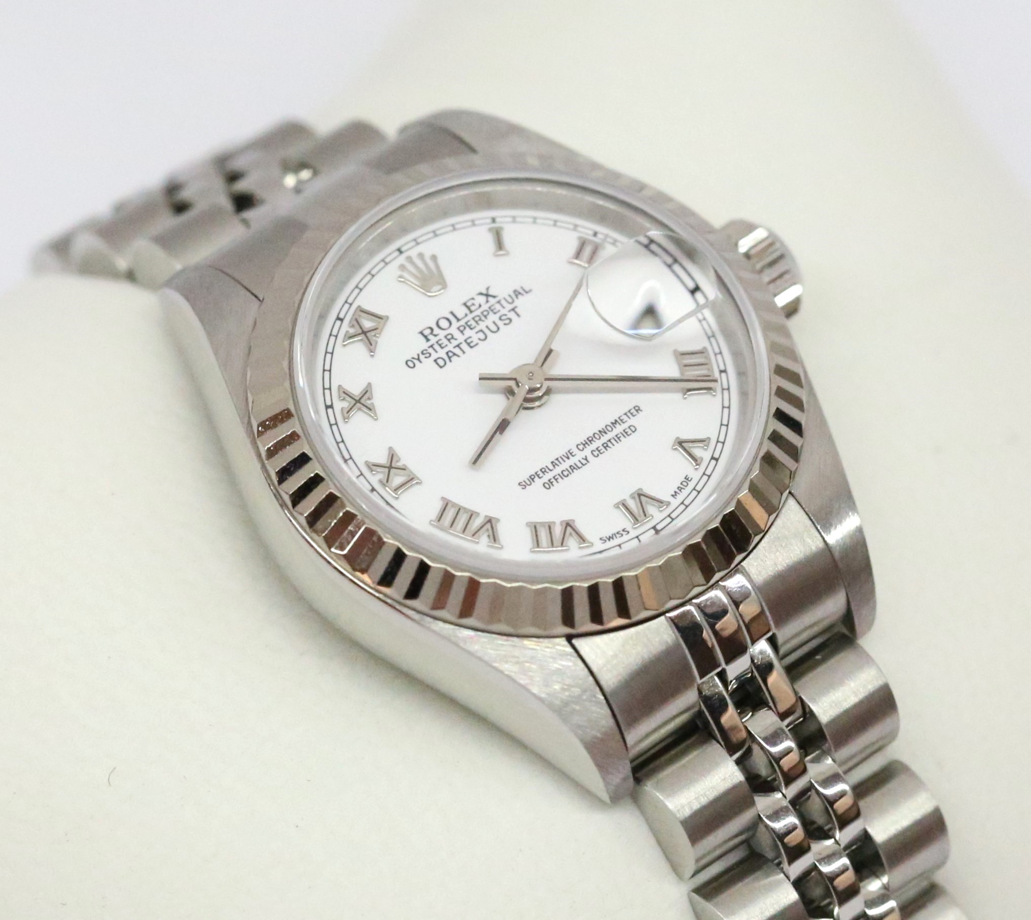 Rolex Datejust 26mm Stainless Steel with 18ct White Fluted Bezel, White Roman Dial, on Rolex Jubilee Bracelet, Reference 79174, Circa: 2000, Complete with Box & Papers