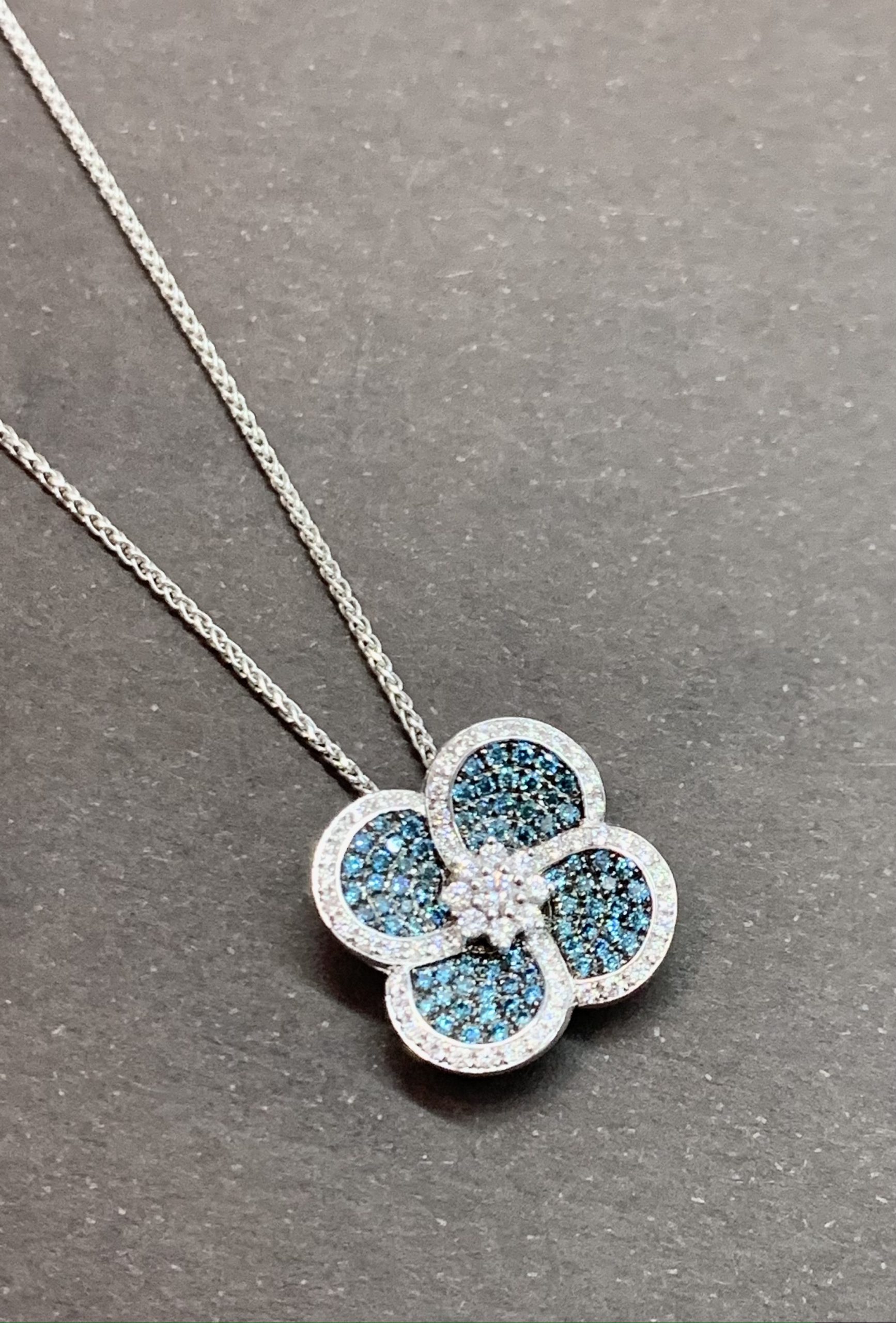 Poniros 18ct white gold diamond pendant, set with total of 0.69ct brilliant cut white diamonds & brilliant cut treated blue diamonds.