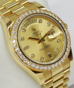 Rolex Oyster Perpetual Day-Date II in 18ct Yellow Gold on a 18ct Yellow Gold President Bracelet, Champagne diamond dial and factory Diamond bezel , Reference: 218348, Ca. 2010, complete with box, book and Rolex Warraty card.
