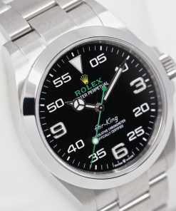Rolex Oyster Perpetual Air King in Rolex Oystersteel Black 60 second dial with Crown guards on a Rolex Oystersteel Flip clock bracelet. Ref: 126900, Ca 2022 with box and papers.