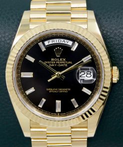Rolex Day-Date 40, in 18ct Yellow Gold, Black Dial with Factory Set Baguette Diamond Hour Markers, on 18ct Yellow Gold Rolex President Bracelet, Ref. 228238, Circa: 2019, with Box, Books, Rolex Warranty Card, Rolex Service Card & Balance of 2 Year Rolex Service Warranty