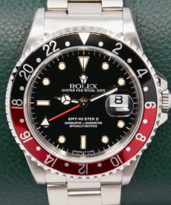 Rolex GMT-Master II "Coke", Stainless Steel, Black Index Dial, Black & Red Bezel, on Stainless Steel Rolex Oyster Bracelet, Ref. 16710, Circa: 1993, Complete with Box, Books, Rolex Warranty Certificate, Rolex Service Card & Balance of 2 Year Rolex Service Warranty
