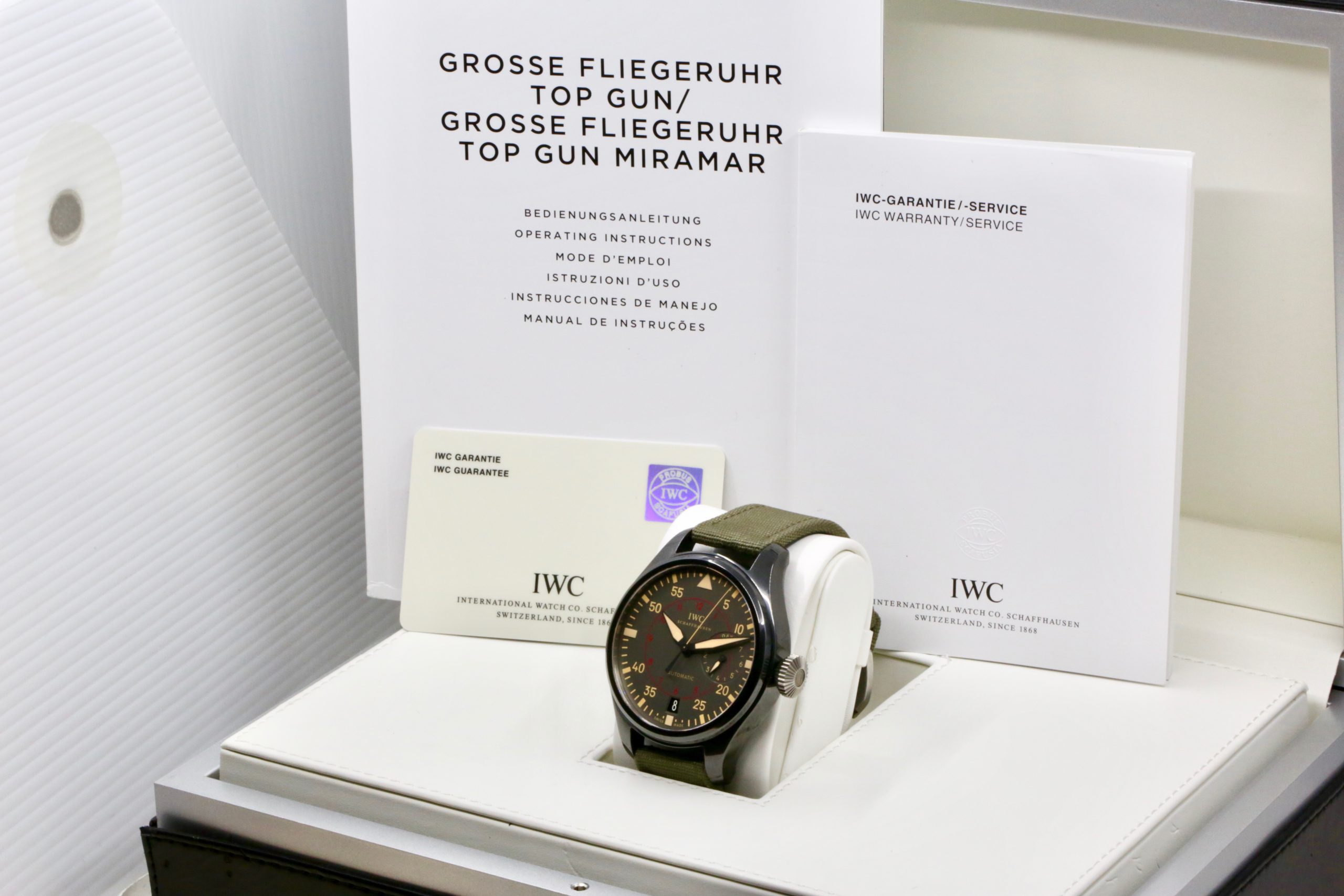 IWC Big Pilot's Top Gun Miramar with Date, Black Ceramic case, Grise Dial with luminescence, Green textile strap with an IWC steel Tang Buckle, Box, Books and IWC Warranty Card, Circa: 2015 - Image 7