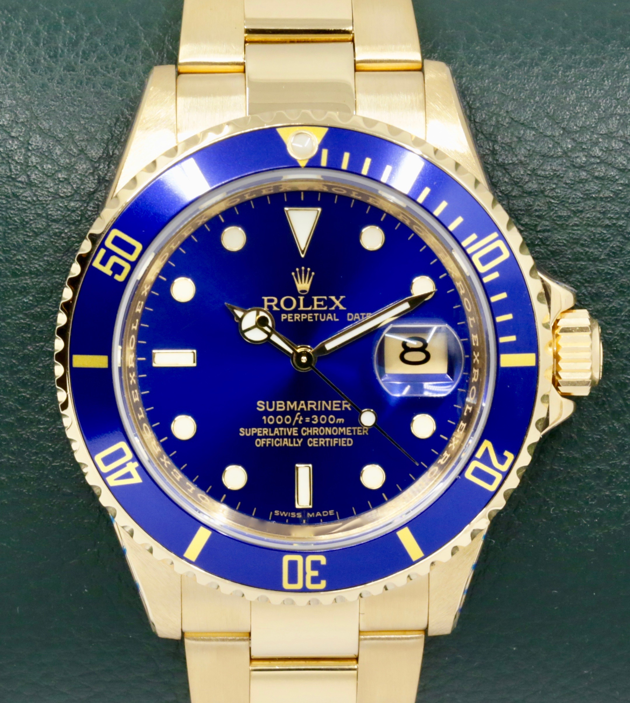 Rolex Oyster Perpetual Submariner Date, in 18ct Yellow Gold, with Blue Index Dial, Blue Aluminum Bezel, on 18ct Yellow Gold Rolex Oyster Bracelet, Ref. 16618, Circa: 2006, with Box, Rolex Service Card & Balance of 2 Year Rolex Service Warranty