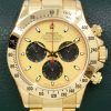 Rolex Cosmograph Daytona, in 18ct Yellow Gold, with "Paul Newman" Champagne Index Dial with Black Sub Dials on 18ct Yellow Gold Rolex Oyster Bracelet, Ref. 116528, Circa: 2002, with Rolex Box, Books, & Rolex Service Card