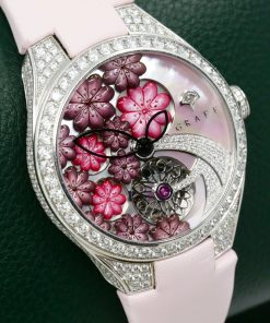 The Graff Floral Automatic Watch in 18ct White Gold, Set with Factory Diamonds on the Case, Lugs, Crown and Bezel, with Mother of Pearl Dial Set with a Floral Design and Diamonds, on a Graff Satin Band with Factory Diamond Set Tang Buckle. Ref: GFA37WGSLD, Box, Book, Additional Graff Satin Strap and Graff Warranty Card.