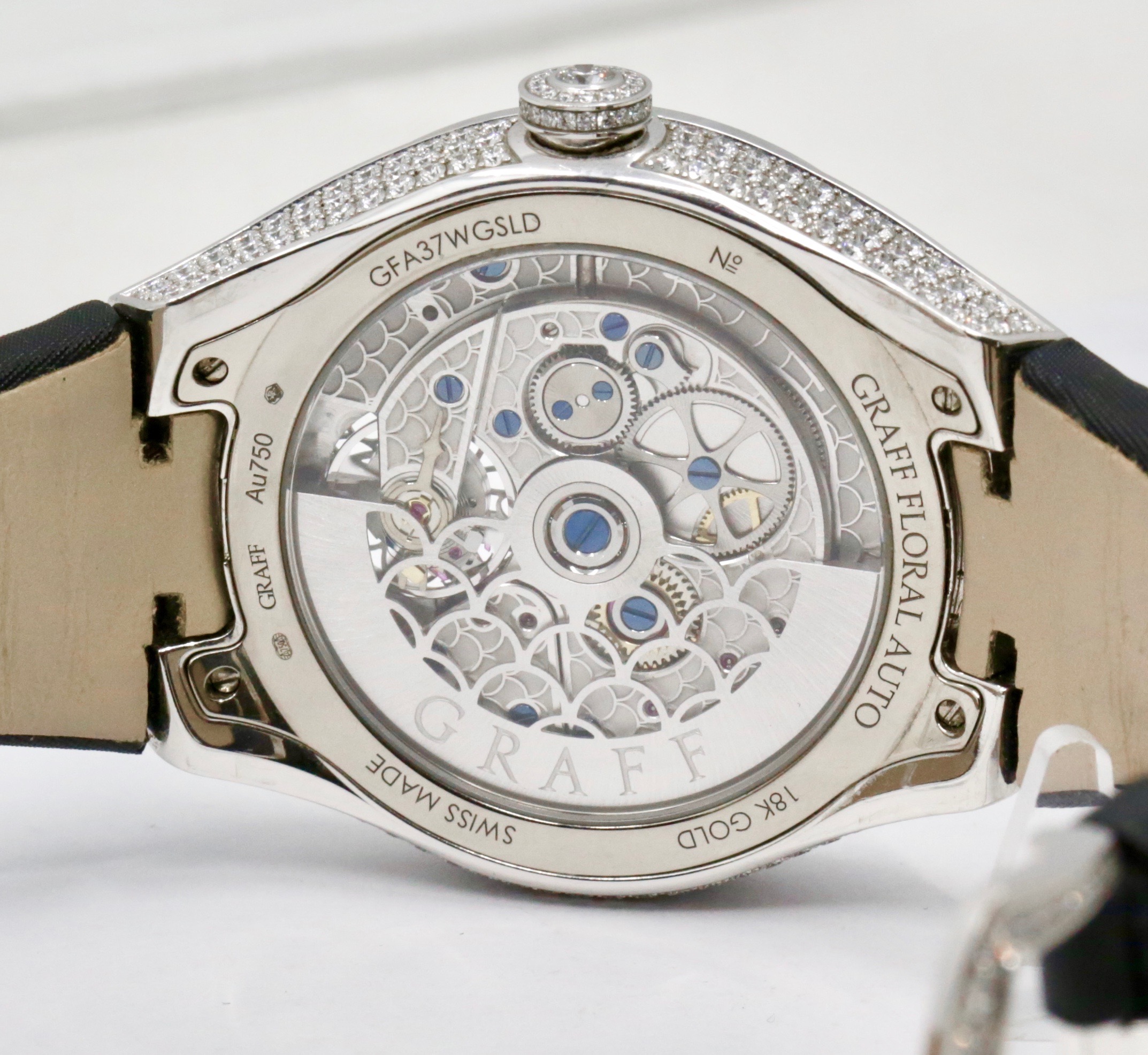 The Graff Floral Automatic Watch in 18ct White Gold, Set with Factory Diamonds on the Case, Lugs, Crown and Bezel, with Mother of Pearl Dial Set with a Floral Design and Diamonds, on a Graff Satin Band with Factory Diamond Set Tang Buckle. Ref: GFA37WGSLD, Box, Book, Additional Graff Satin Strap and Graff Warranty Card. - Image 10