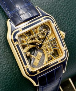 Alternative view of Cartier Santos Dumont Skeleton Watch with Micro-Rotor, in 18ct Yellow Gold with Navy Blue Enamelling, on Navy Blue Cartier Alligator Strap with 18ct Yellow Gold Cartier Tang Buckle, Ref. WHSA0031, Circa: 2024, with Box, Papers & Balance of 8 Year extended Cartier Factory Warranty. "This model is Limited to 150 pieces"