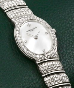 Vacheron Constantin Ladies Watch in 18ct White Gold, Diamond Set Bezel with a Mother Of Pearl Dial Set with Diamonds at 3, 6, 9. Integrated 18ct White Gold Bracelet Set with Diamonds. Ref: 27036/PB is part of the Absolues Collection with a Quartz Movement. Circa 1990's