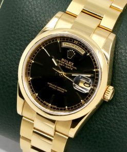 Rolex Day-Date, in 18ct Yellow Gold, Black Index Dial, with the Rare Domed Bezel, on 18ct Yellow Gold Rolex Oyster Bracelet, Ref. 118208, Circa: 2004, with Rolex Box, Books, Rolex Folder, Rolex Warranty Certificate, Rolex Service Invoice & Balance of 2 Year Rolex Service Warranty