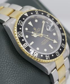 Alternative view of Rolex Oyster Perpetual GMT Master 2 in stainless steel & 18Ct Yellow gold, Black Index dial on a Rolex Steel and 18ct Yellow gold Oyster bracelet  with Box, Book, Tags and Rolex Warranty Paper. Ca2004