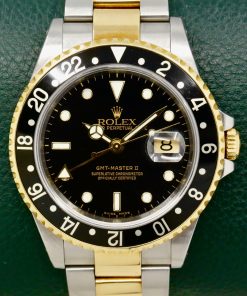 Rolex GMT-Master II in Stainless Steel & 18ct Yellow Gold, Black Index Dial, Black Aluminium Bezel, on Stainless Steel & 18ct Yellow Gold Bracelet, Ref. 16713, Circa: 2004, with Box, Books, Swing Tags & Rolex Warranty Certificate