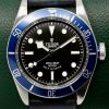 Tudor Heritage Black Bay "Smiley", 41mm Stainless Steel Case, Black Index Dial, Blue Aluminium Bezel, on Black Tudor Leather Strap with Stainless Steel Tudor Deployant, Ref. 79220B, Circa: 2014, Complete with Box, Books, Tudor Warranty Card & Tudor Service Card