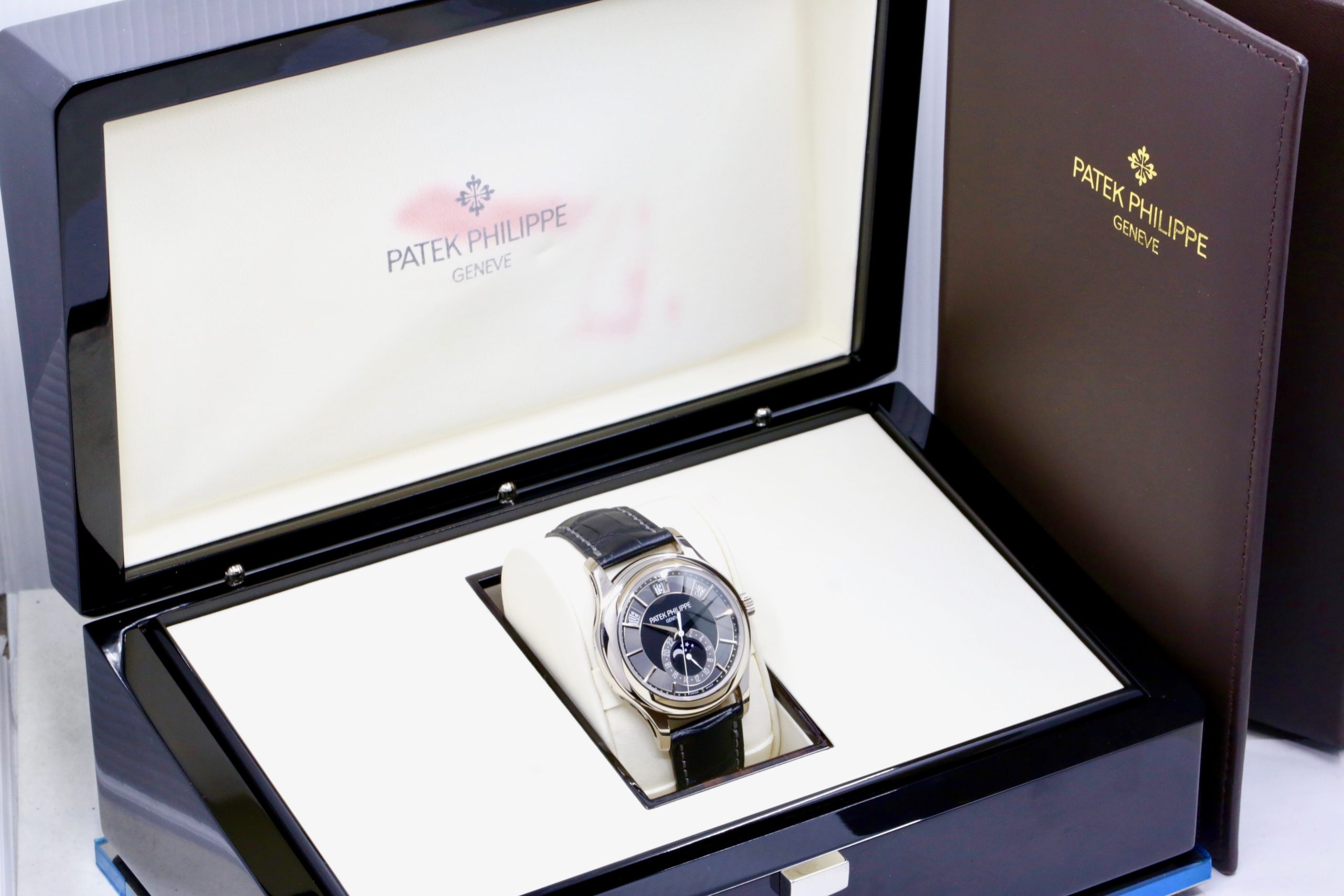 Patek Philippe Ref. 5205G-010 Annual Calendar, in 18ct White Gold, with Grey & Black Index Dial, Day, Date, Month, & Moon Phase Display, on Black Patek Philippe Alligator Strap with 18ct White Gold Patek Philippe Tang Buckle, Sold New in 2012, with Box & Papers - Image 9