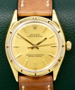 Rolex Oyster Perpetual in 18ct Yellow Gold, 18ct Engine Turned Bezel, Champagne Index Dial, on Tan Artisan Leather Strap. Ref. 1007, Circa 1960’s - $8,800 inc GST!!